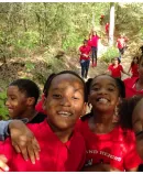 a joyful group of children on a hike in a forest